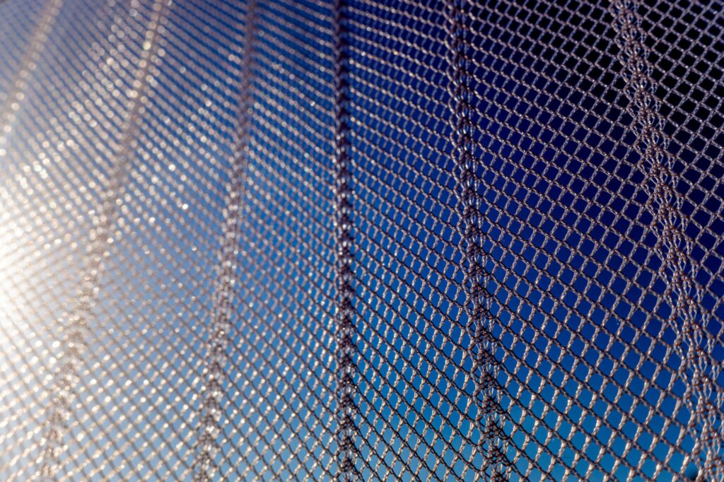net made of nylon protects a summer window from mosquitoes and insects, close up detail.